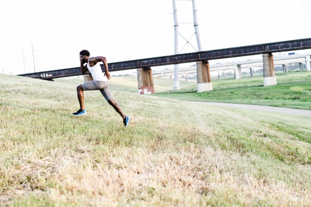 Man doing a HIIT running sprint up a hill.